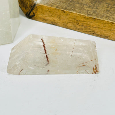 rutilated quartz with decorations in the background