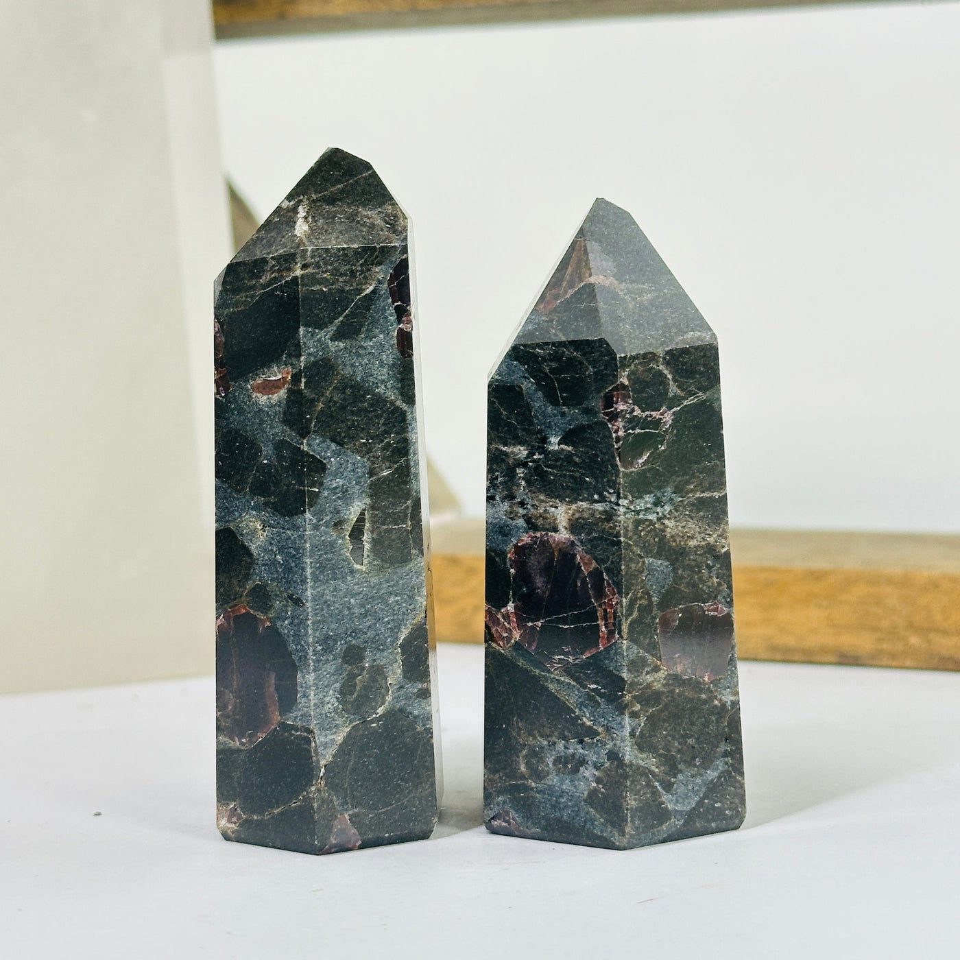 hematite point with decorations in the background