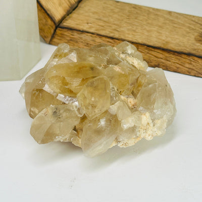 citrine cluster with decorations in the background 