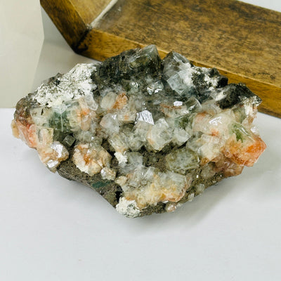 zeolite with stilbite on matrix with decorations in the background