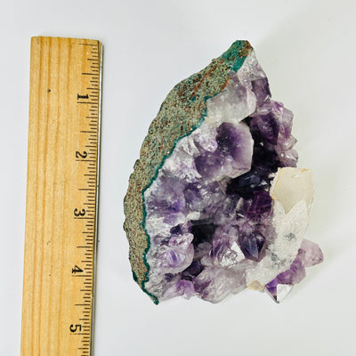 amethyst cluster with decorations in the background