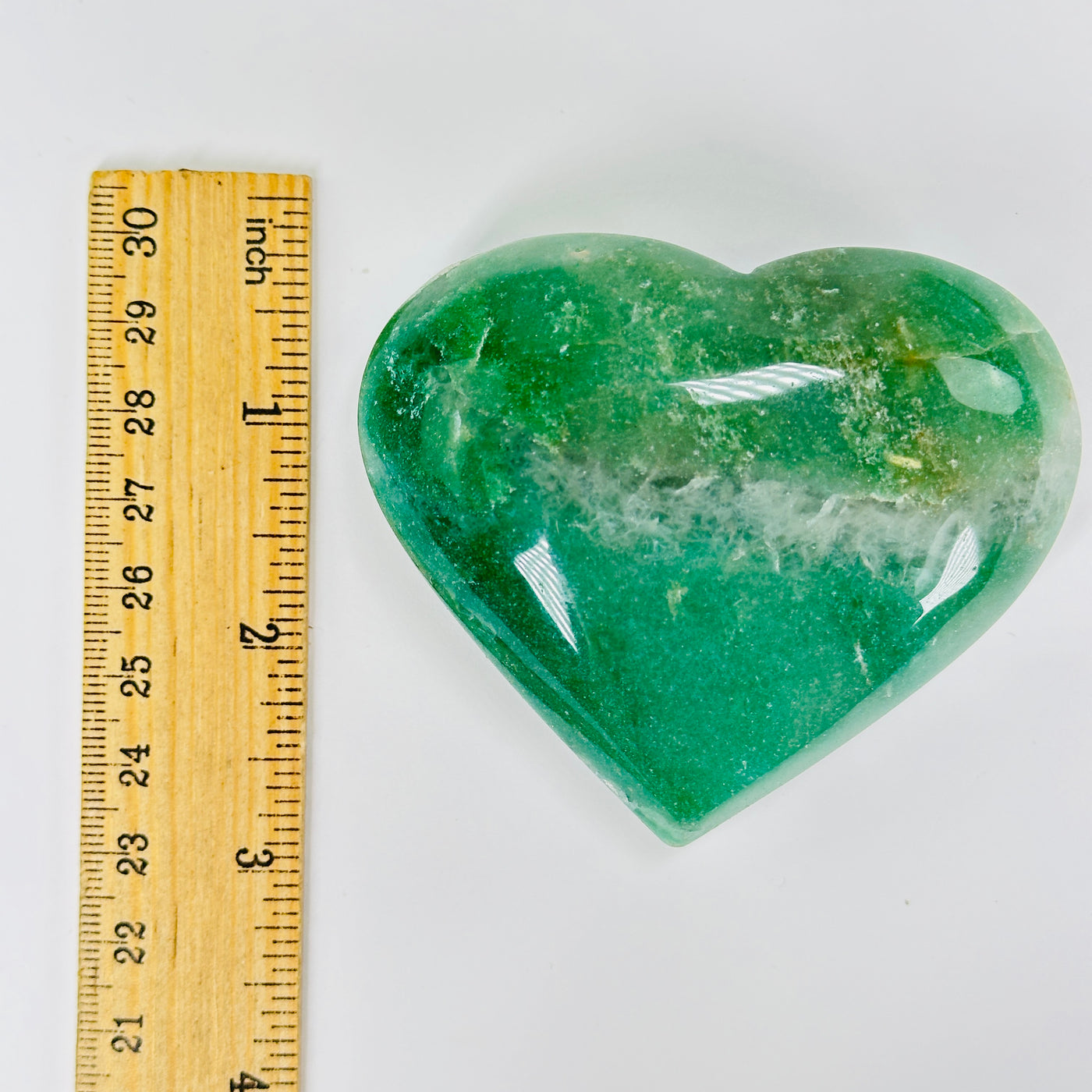 aventurine heart with decorations in  the background