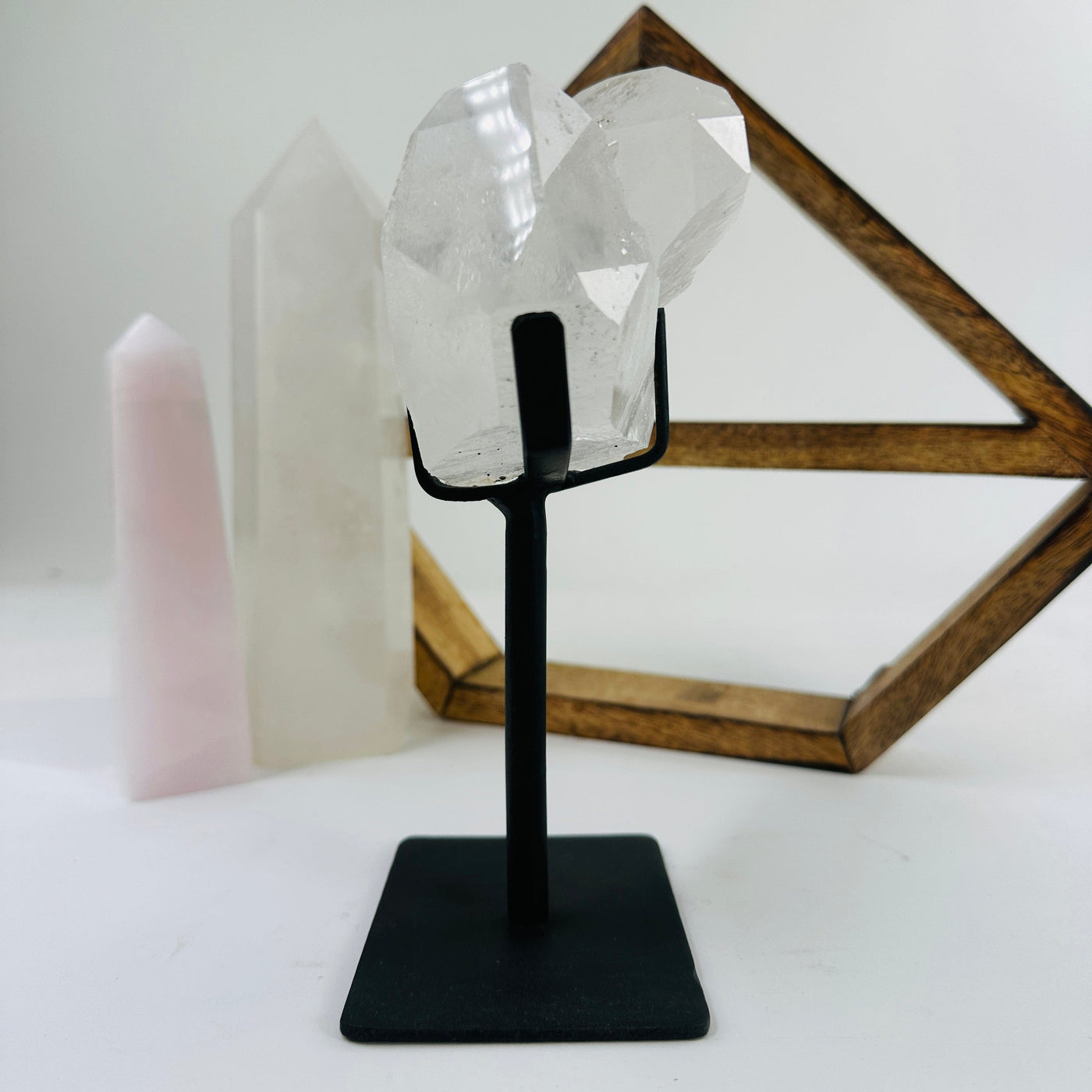 crystal quartz on metal stand with decorations in the background