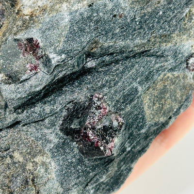 garnet on hematite matrix with decorations in the background