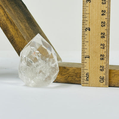 crystal quartz point with decorations in the background