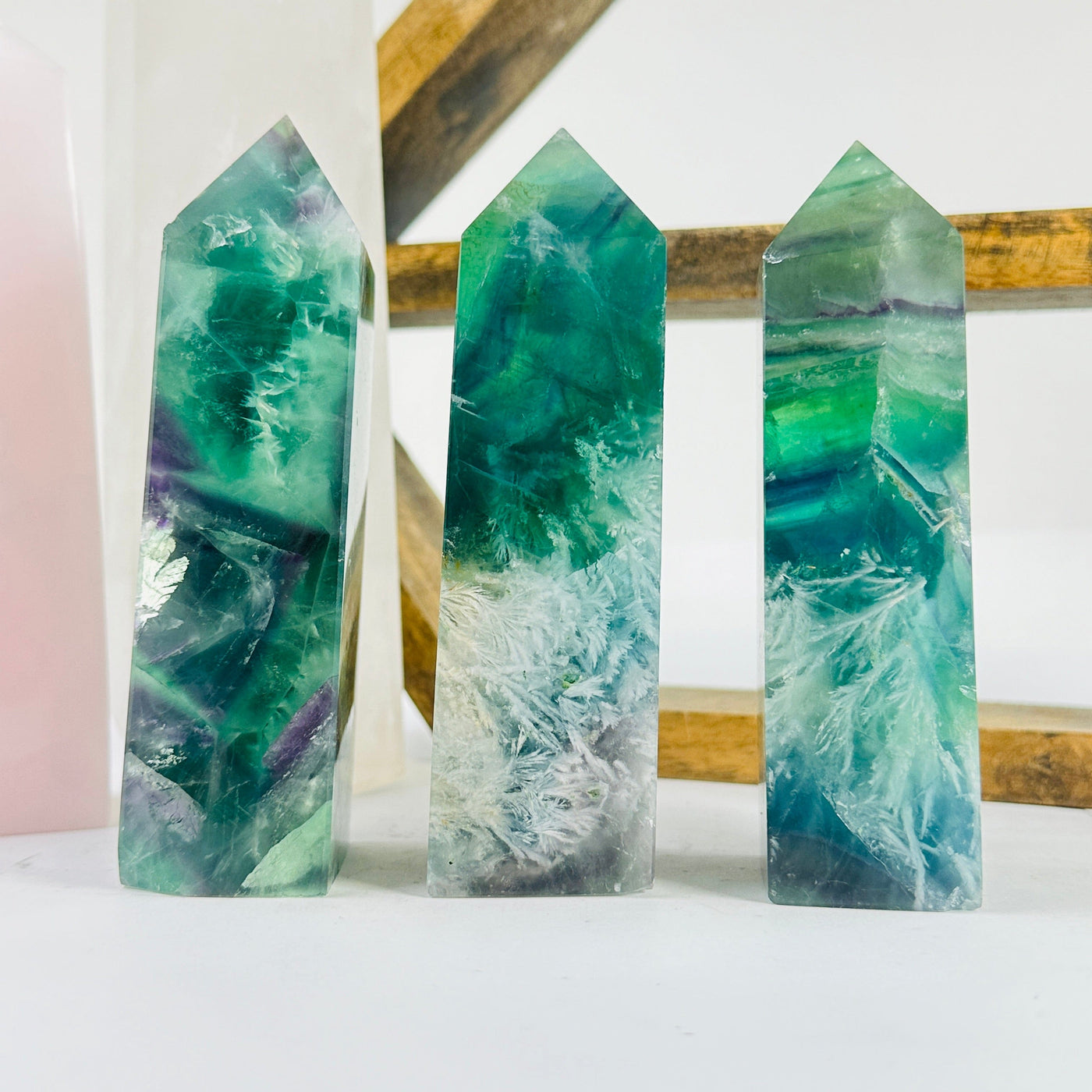 fluorite point with decorations in the background