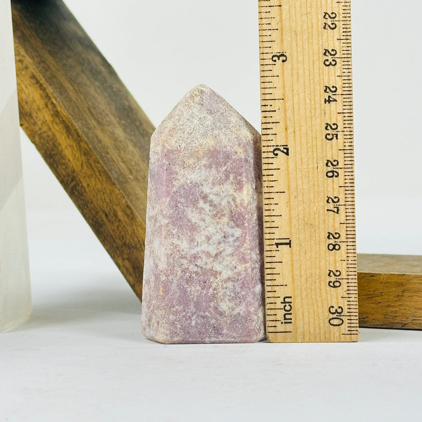 tourmaline point next to a ruler for size reference