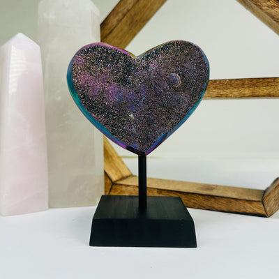 amethyst heart on stand with decorations in the background