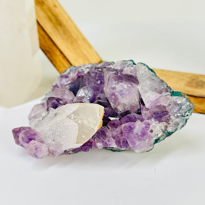 amethyst cluster with decorations in the background