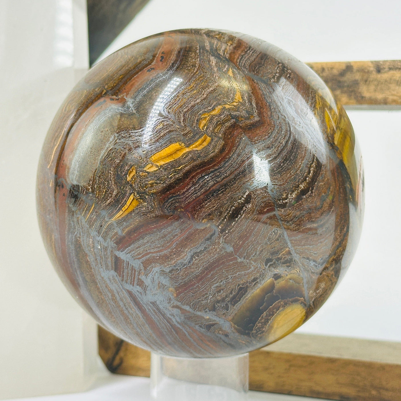 tigers eye sphere with decorations in the background