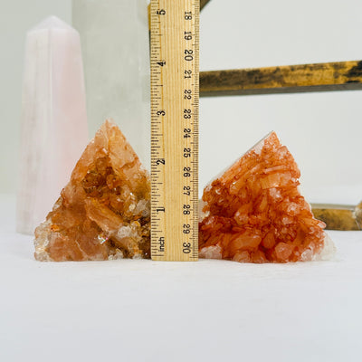 tangerine quartz points next to a ruler for size reference