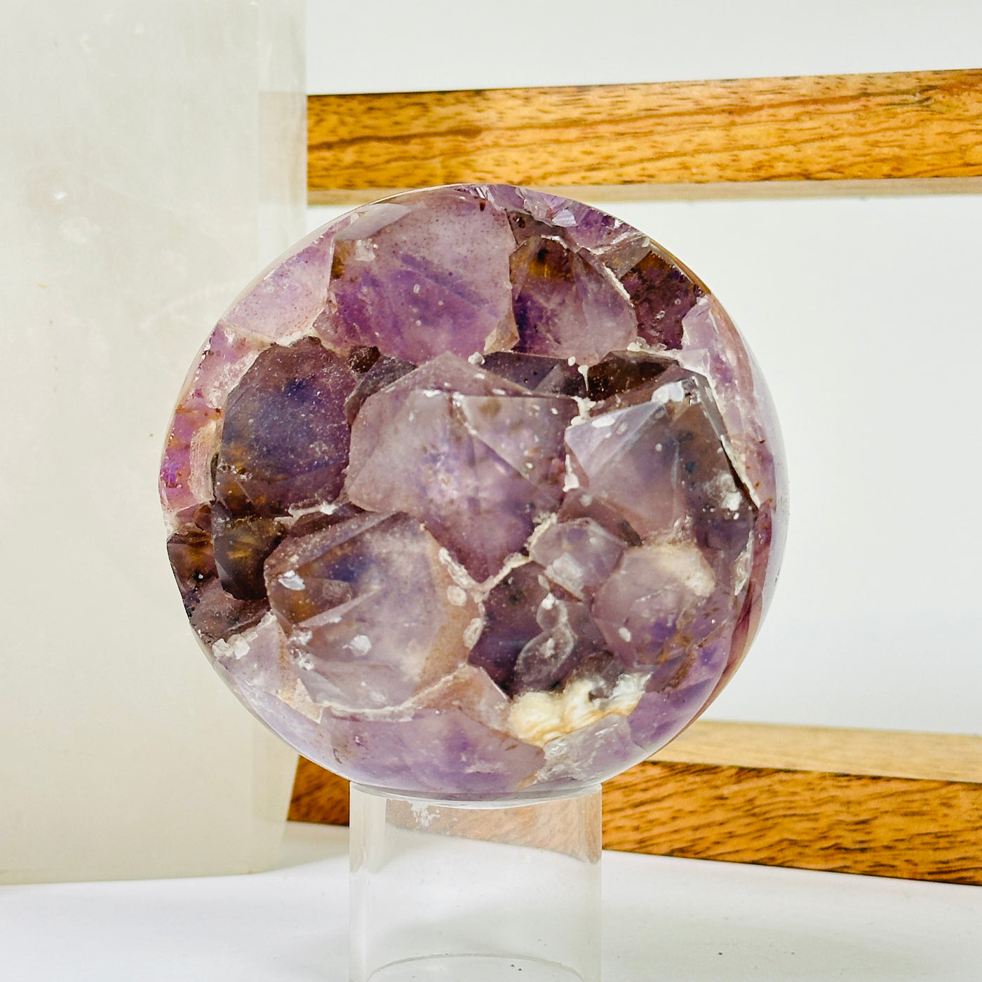 amethyst sphere with decorations in the background