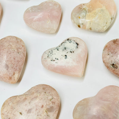 pink opal hearts with decorations in the background