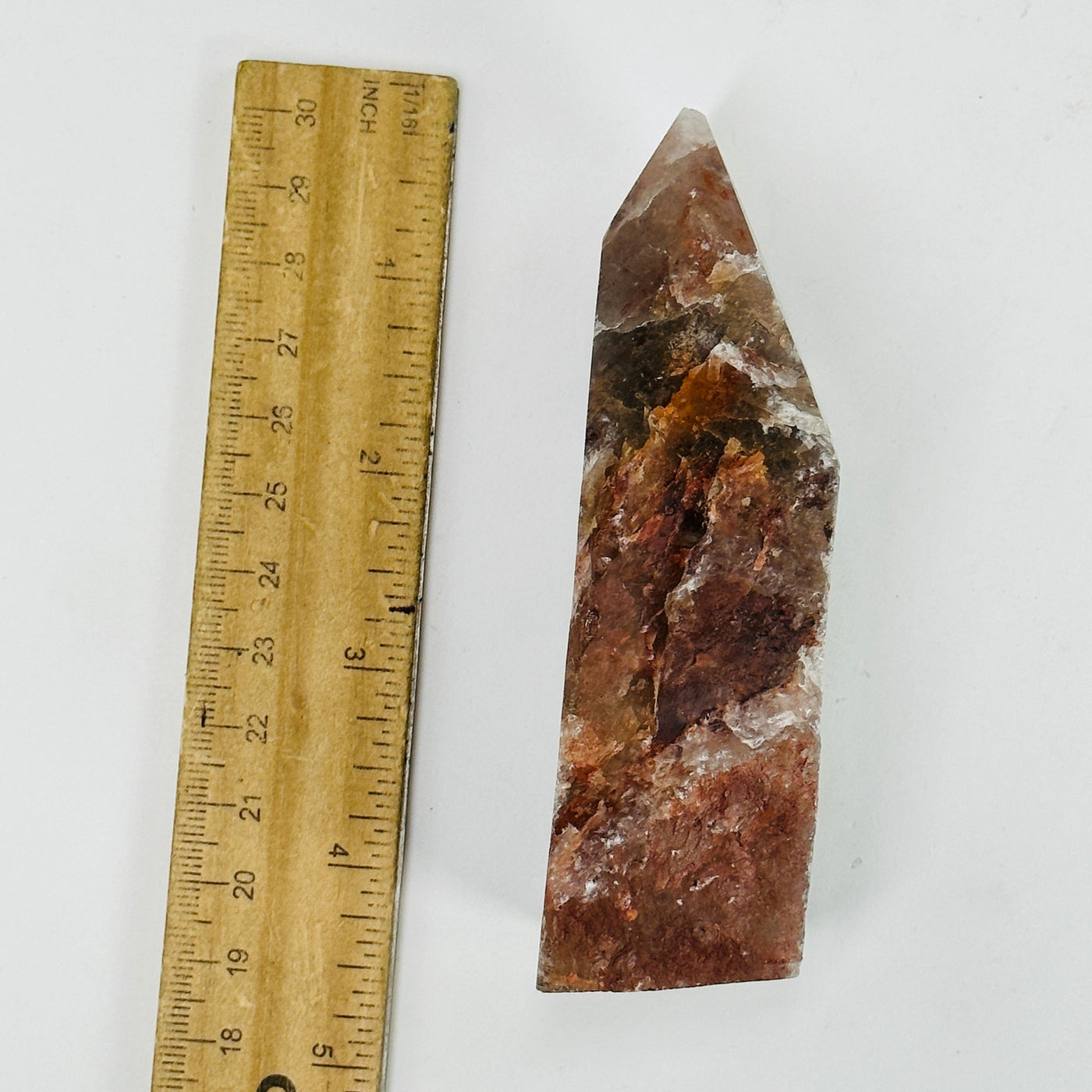 hematoid point next to a ruler for size reference