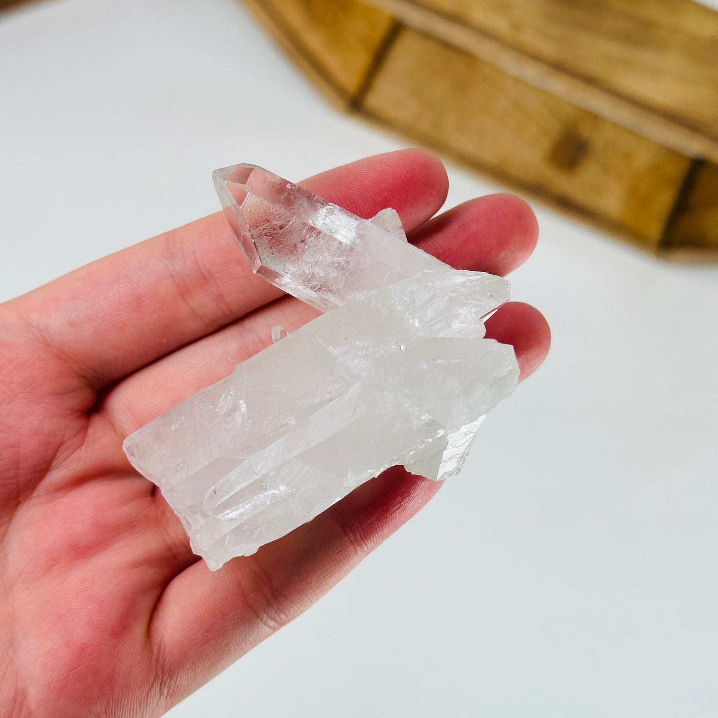 hand holding up crystal quartz cluster