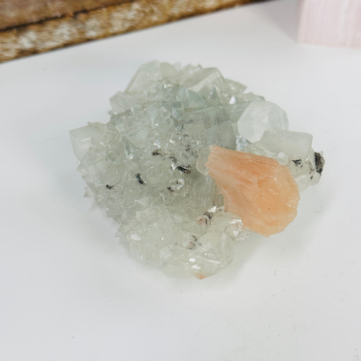 peach apophyllite with Stilbite with decorations in the background