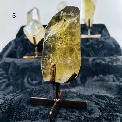 citrine on metal stand with others in the background