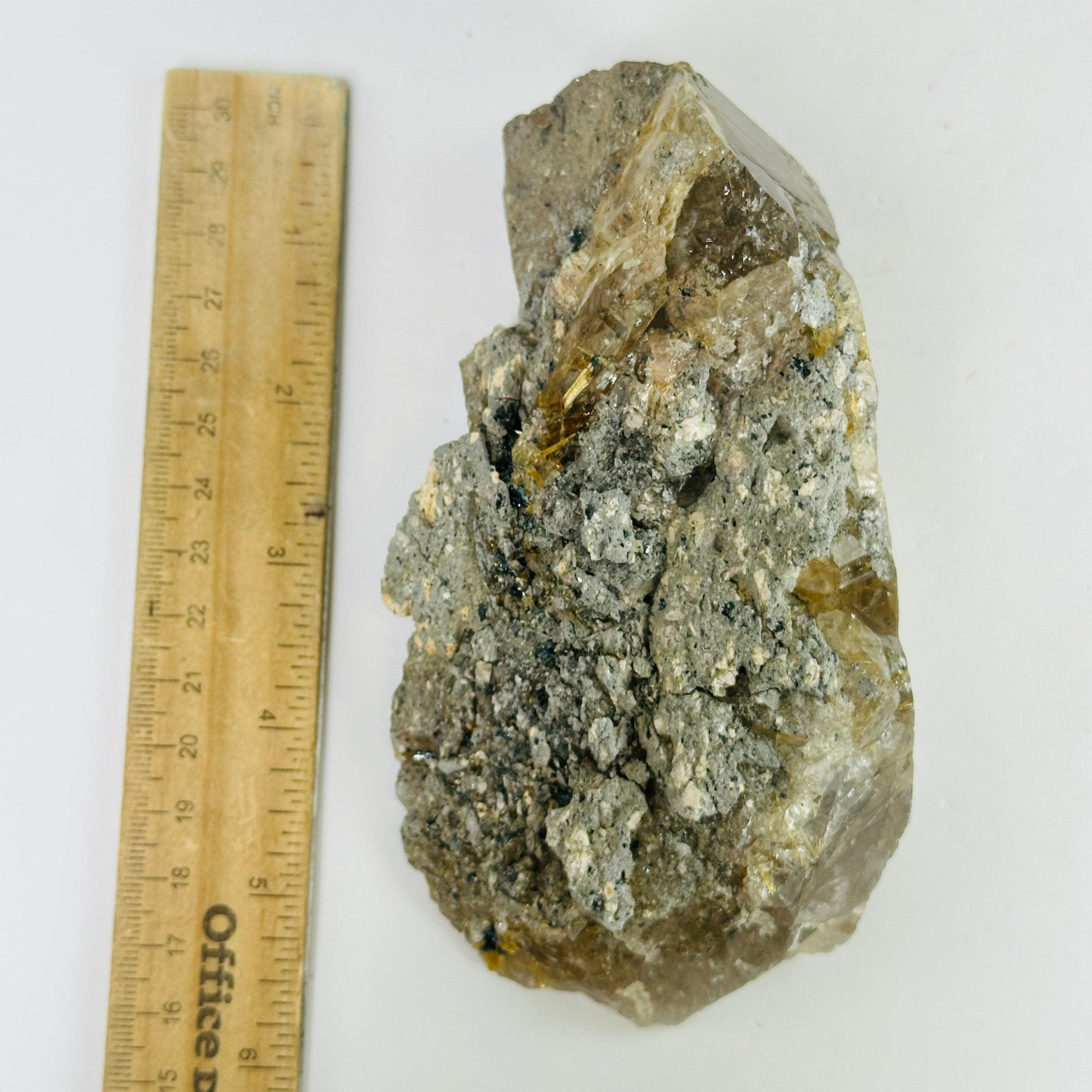 rutile quartz next to a ruler for size reference