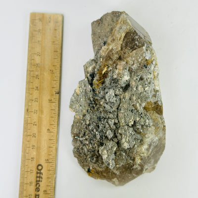 rutile quartz next to a ruler for size reference