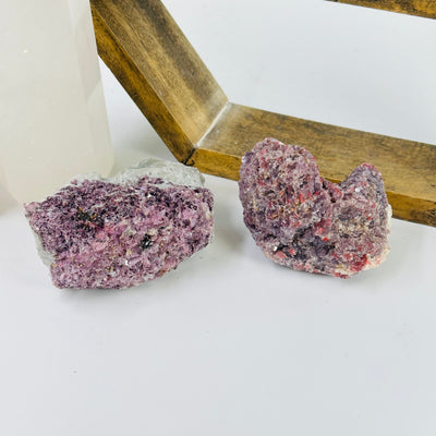 lepidolite cluster with decorations in the background