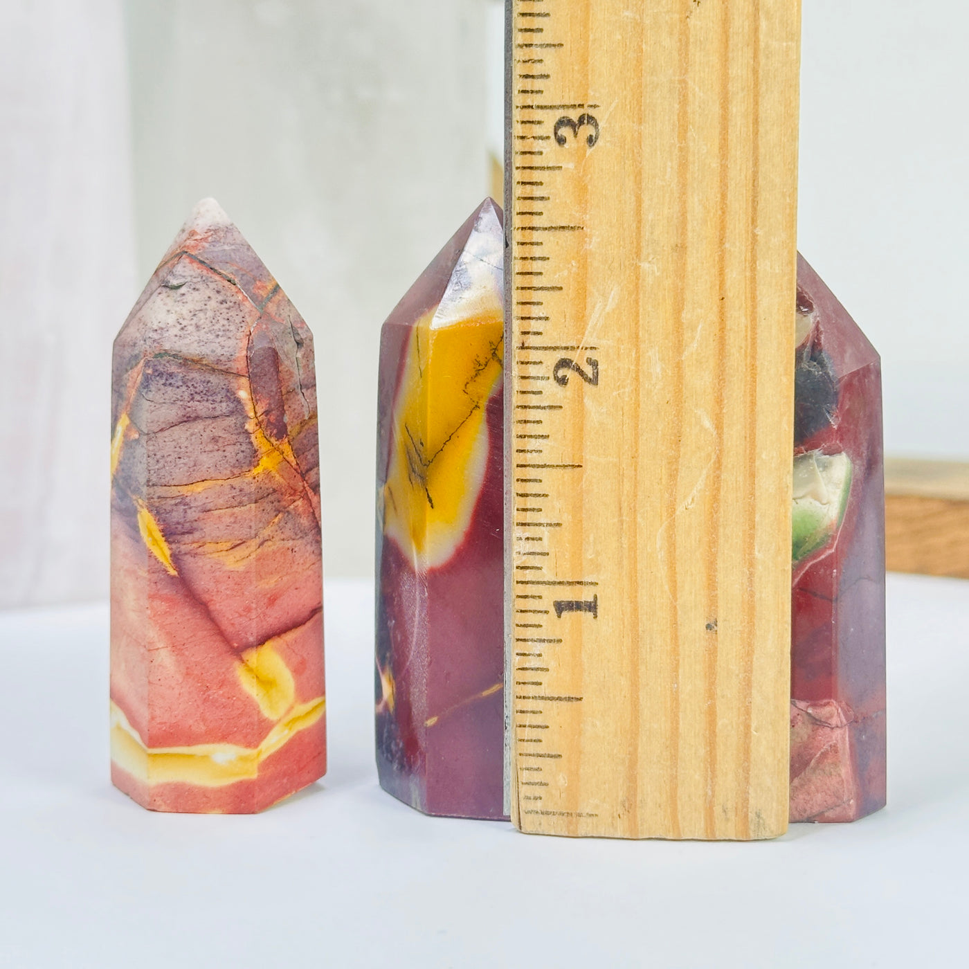 mookaite points next to a ruler for size reference