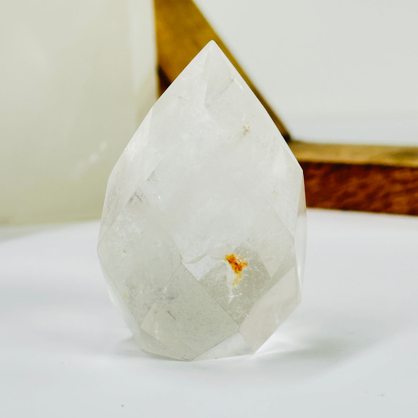 crystal quartz egg with decorations in the background