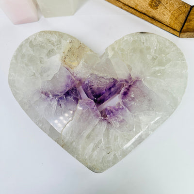 amethyst heart with decorations in the background