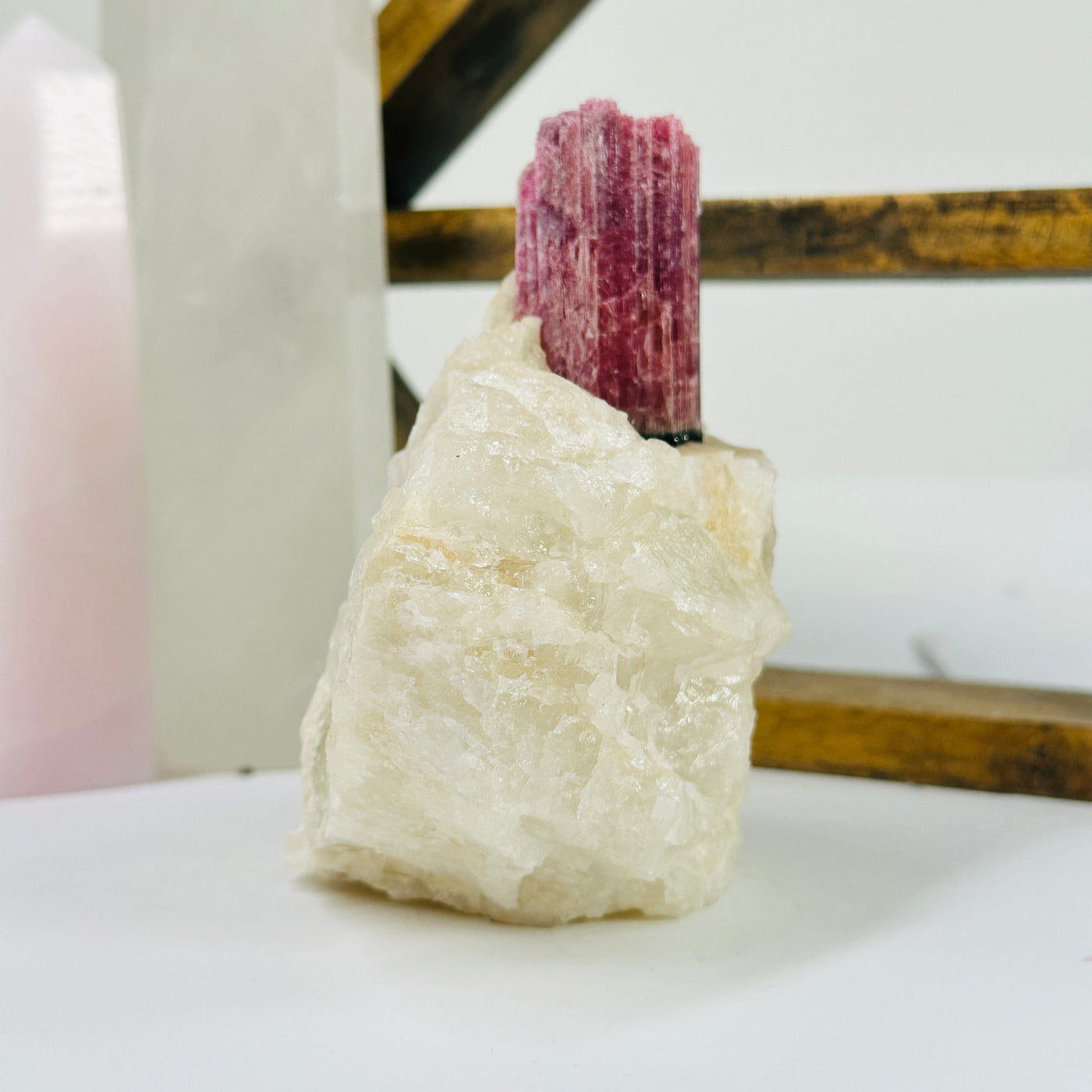 watermelon tourmaline with decorations in the background