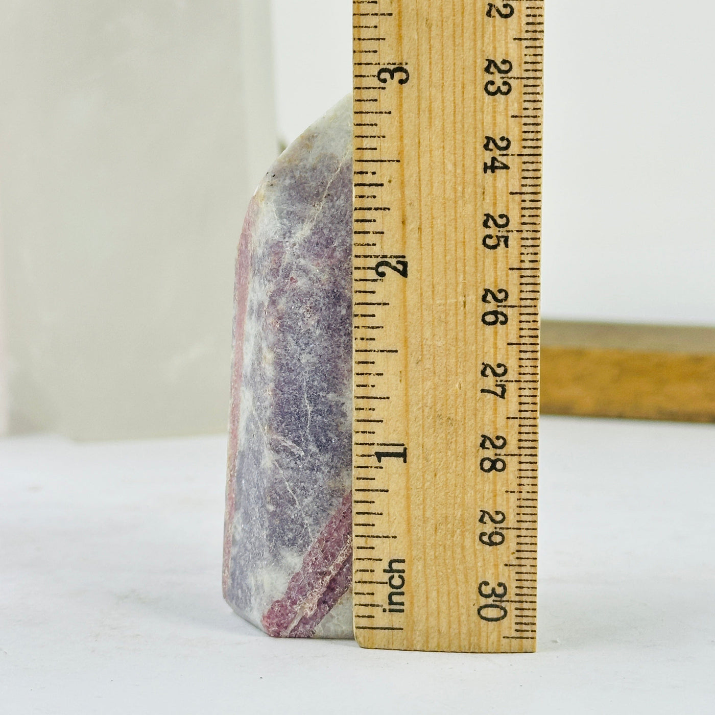 tourmaline point next to a ruler for size reference