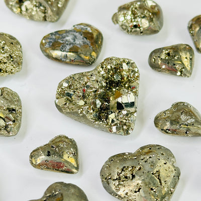 pyrite heart with decorations in the background