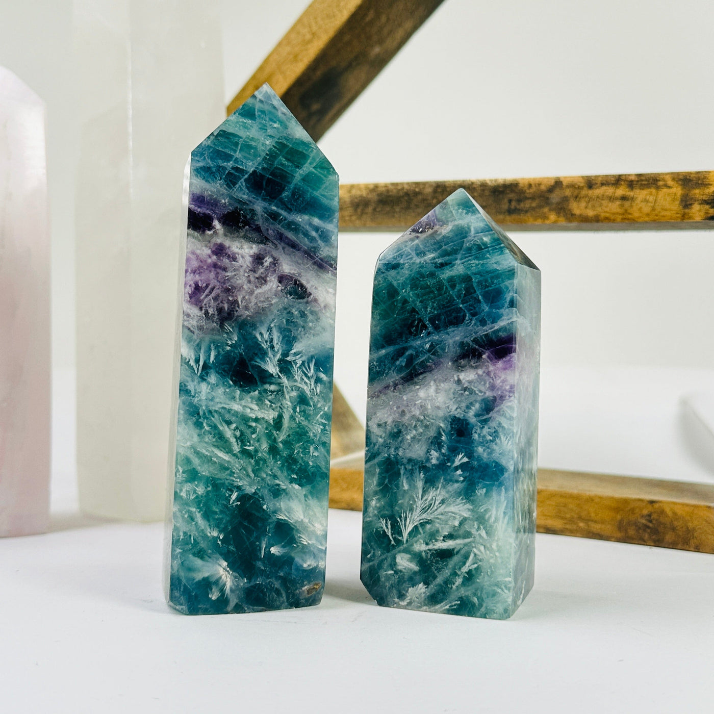 fluorite point with decorations in the background