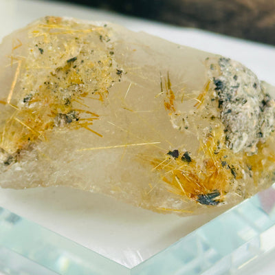 rutilated quartz with decorations in the background