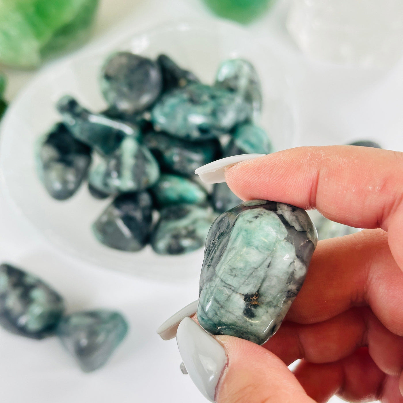 Emerald Crystal Large Tumbled Stone - By the Piece one in hand for size reference with others in the background