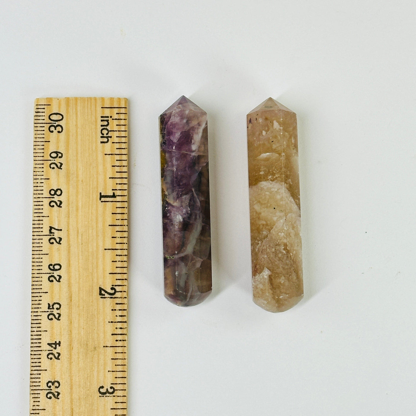 amethyst massage wand next to a ruler for size reference