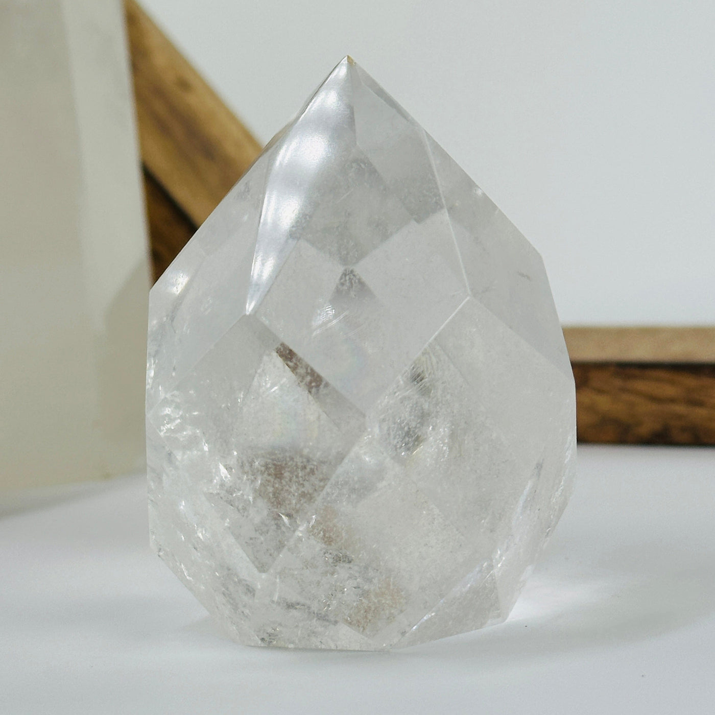 crystal quartz faceted egg with decorations in the background