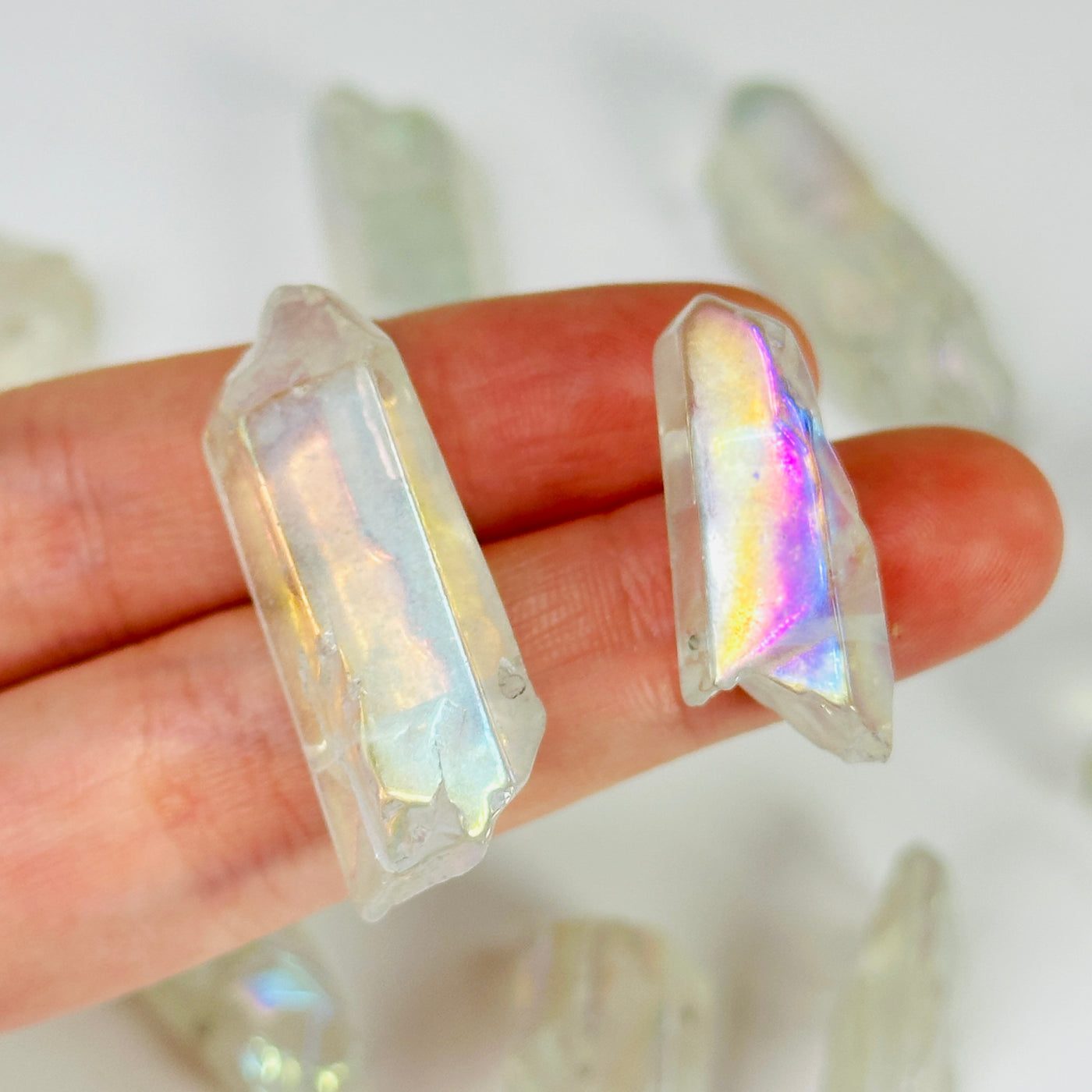 aura quartz crystal with decorations in the background