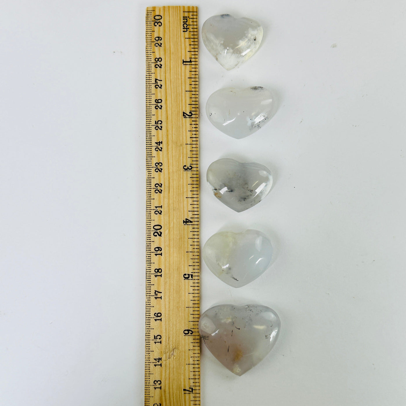 FLOWER AGATE HEARTS next to a ruler for size reference