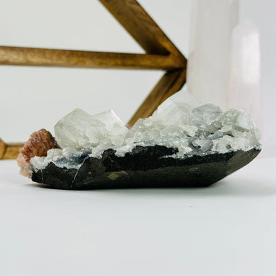 stilbite with apophyllite with decorations in the background
