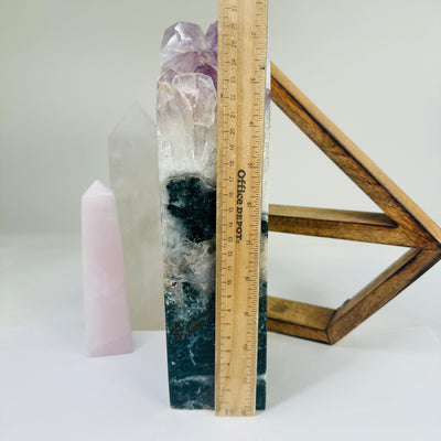 amethyst point next to a ruler for size reference