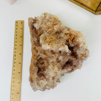 lithium quartz cluster next to a ruler for size reference