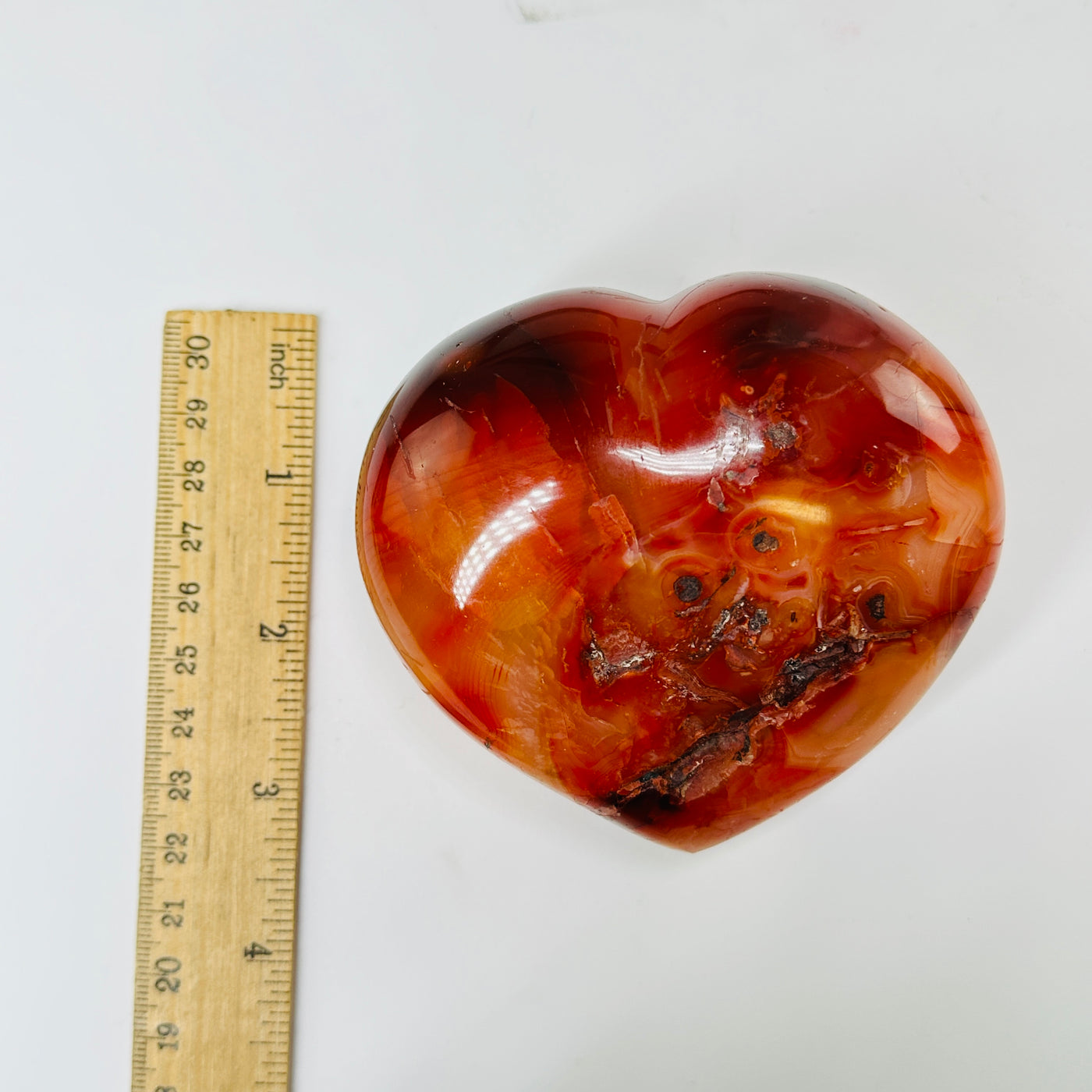 carnelian heart with decorations in the background