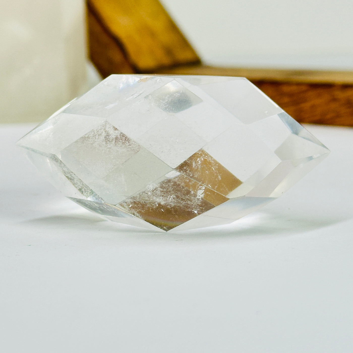 crystal quartz point with decorations in the background