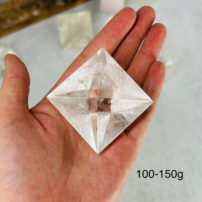 hand holding up 100-150g crystal quartz shape