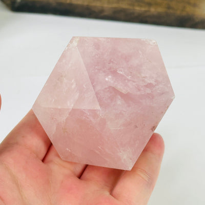 rose quartz dodecahedron with decorations in the background