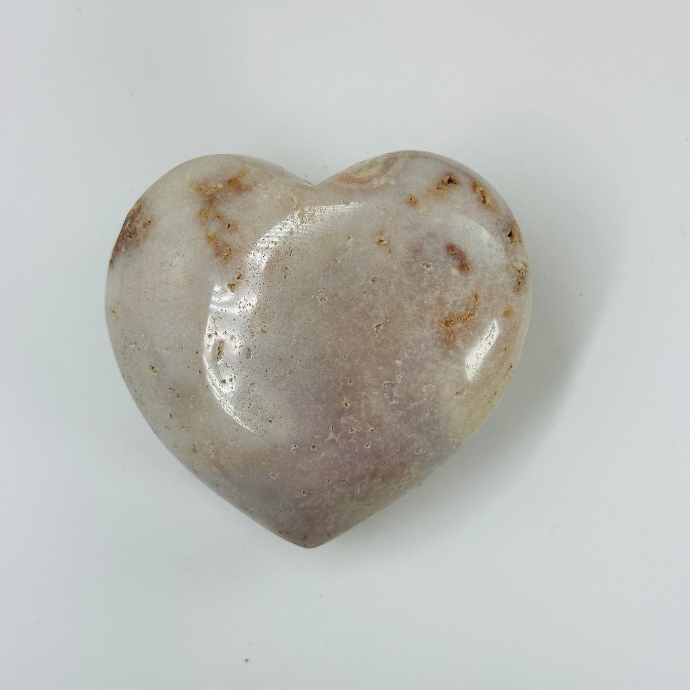 pink amethyst heart with decorations in the background