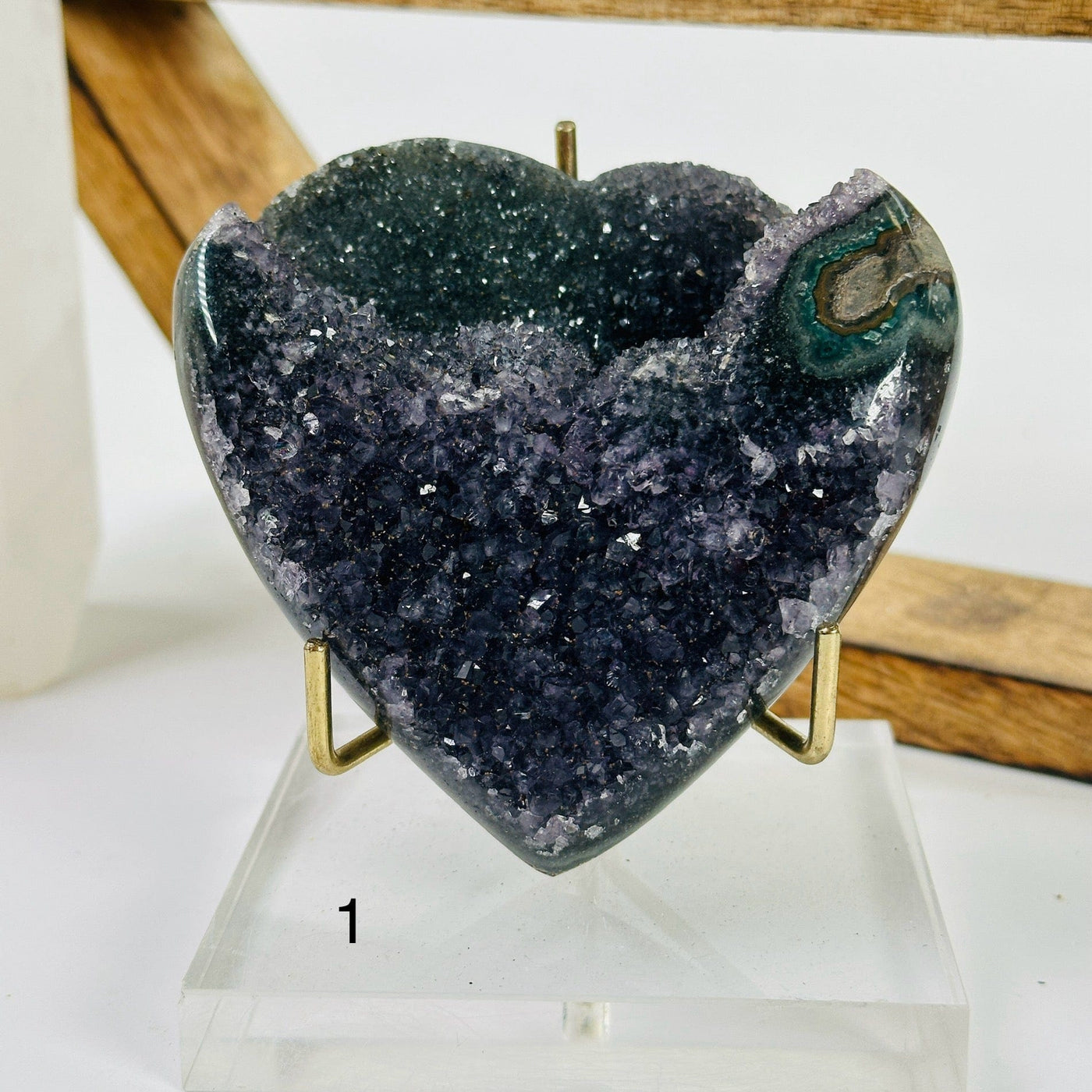 amethyst heart with decorations in the background