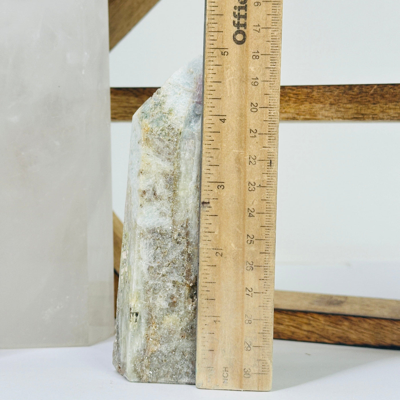 pink tourmaline point next to a ruler for size reference