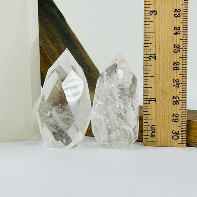 crystal quartz point with decorations in the background