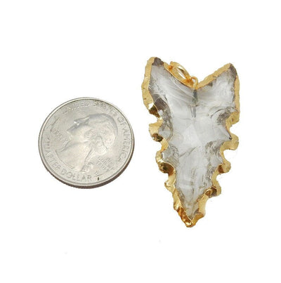 Glass Arrowhead Pendant with Electroplated 24k Gold Edge next to a quarter for size reference