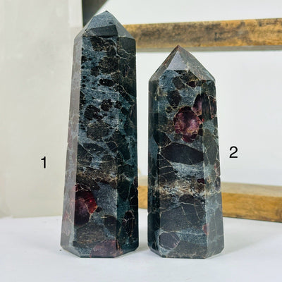 hematite point with decorations in the background